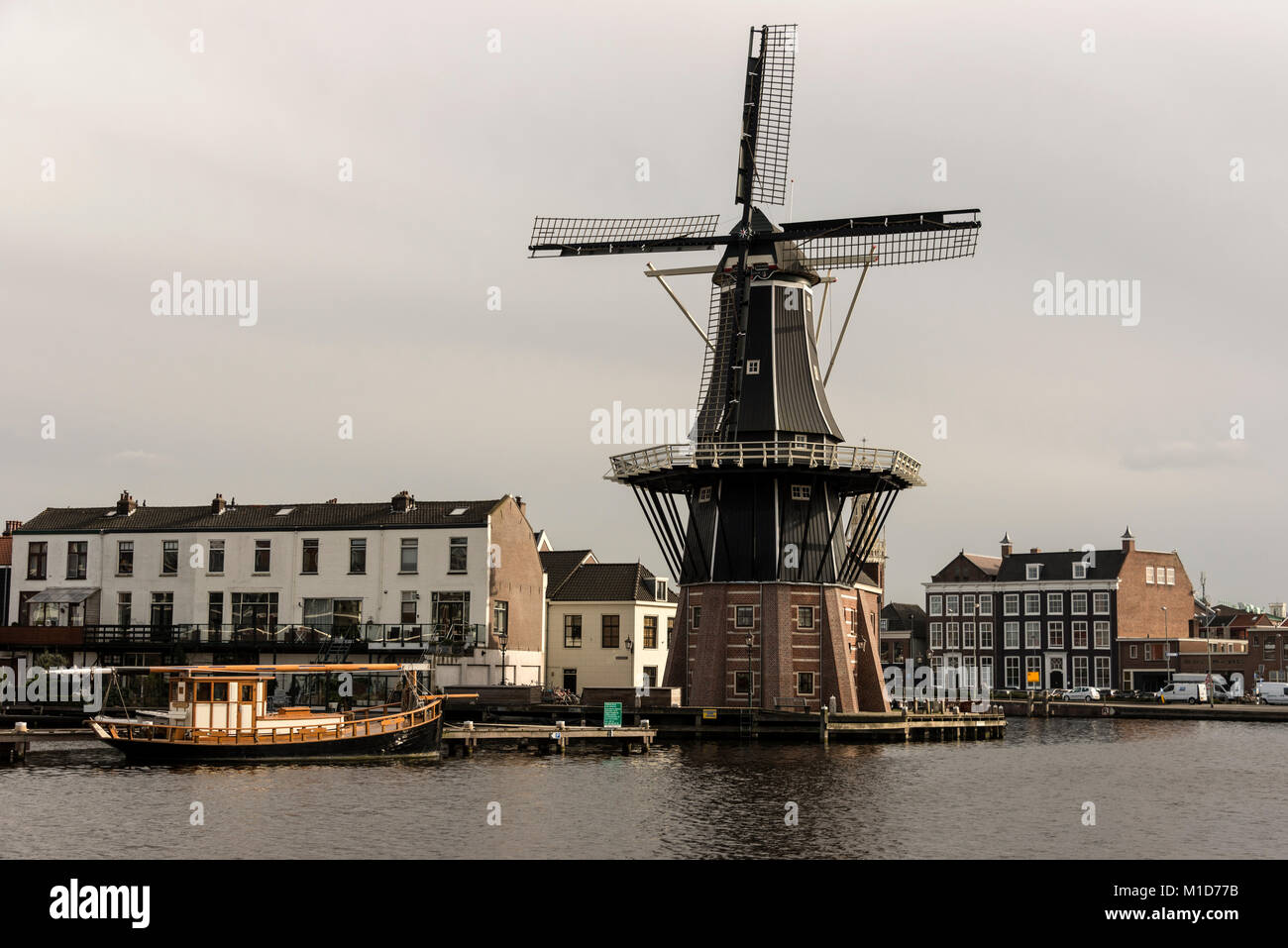 On the bend of the Spaarne River that cuts its way through the centre of Haarlem is one of Haarlem’s most recognised landmarks, the Molen de Adriaan w Stock Photo