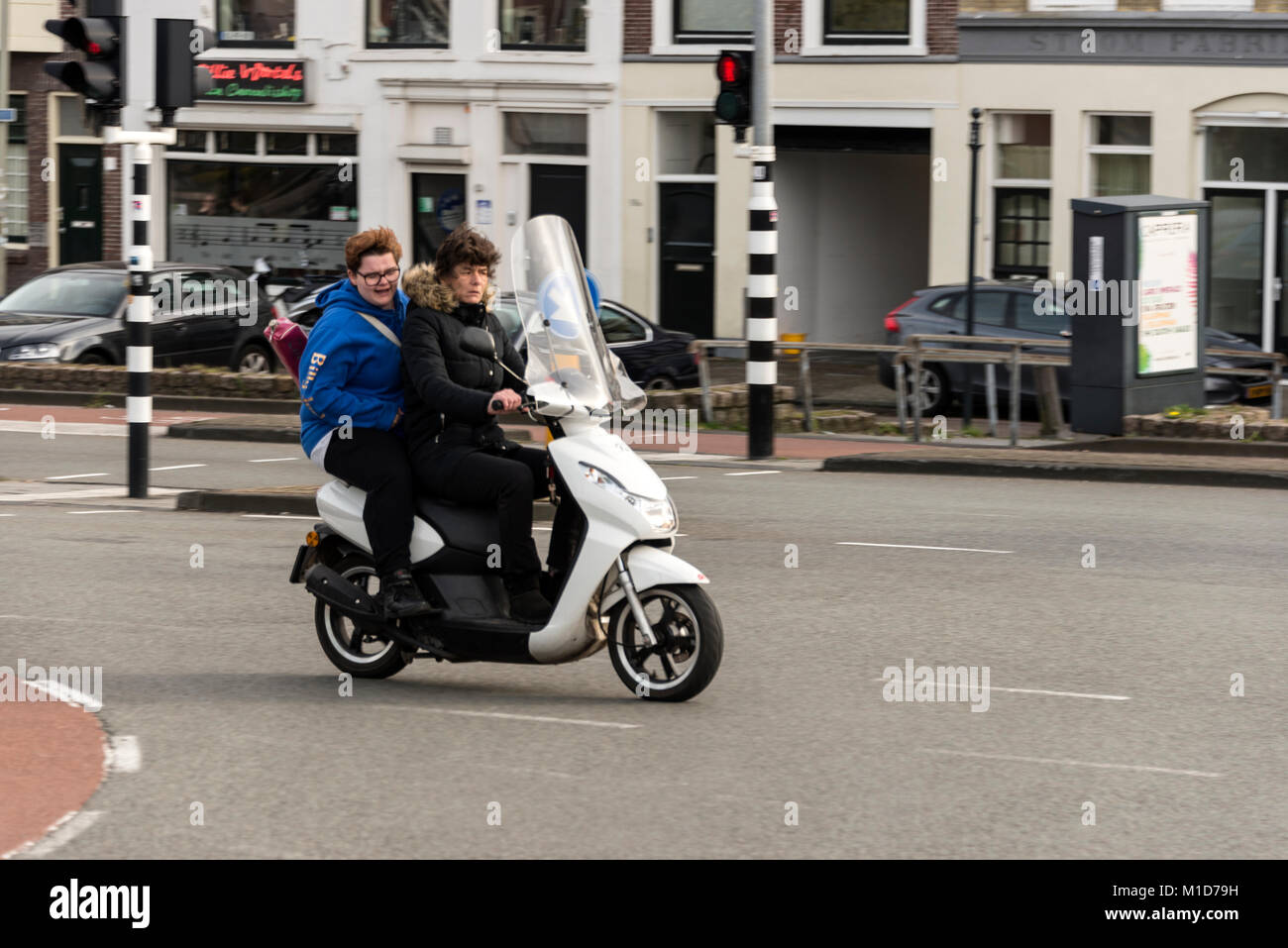 Under Dutch law it is not a requirement for anyone owing a motorbike or scooter under 30cc to wear a crash helmet. Stock Photo