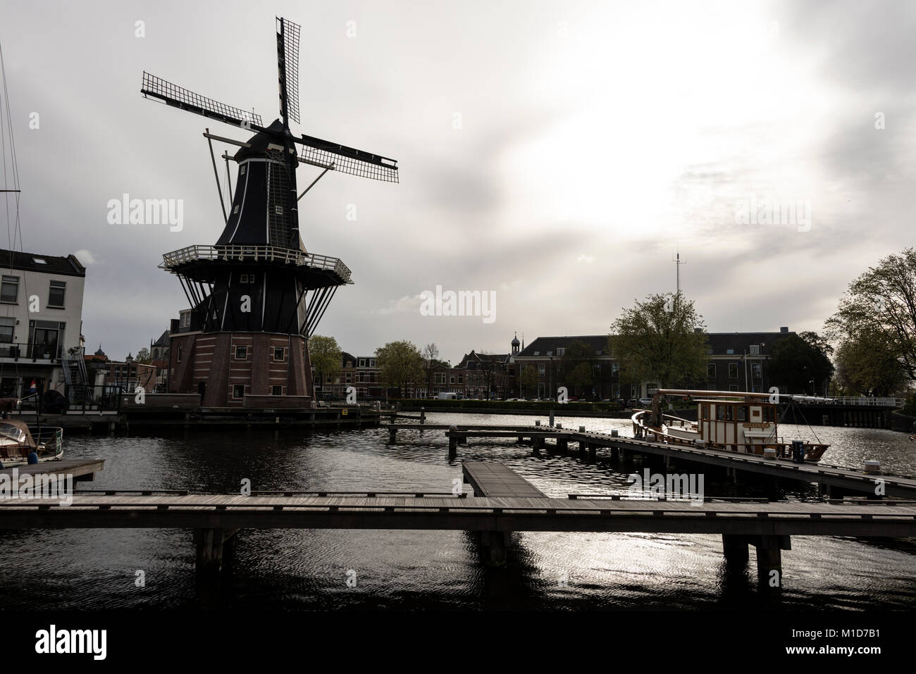 On the bend of the Spaarne River that cuts its way through the centre of Haarlem is one of Haarlem’s most recognised landmarks, the Molen de Adriaan w Stock Photo