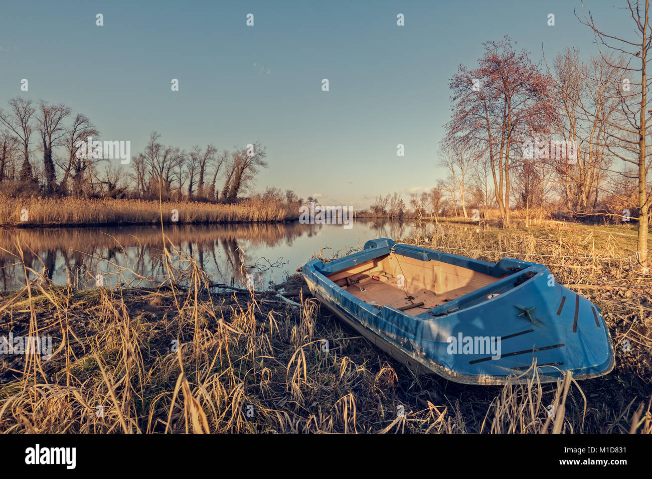 Fishing boat moored on the shore of the lake. Natural landscape Stock ...