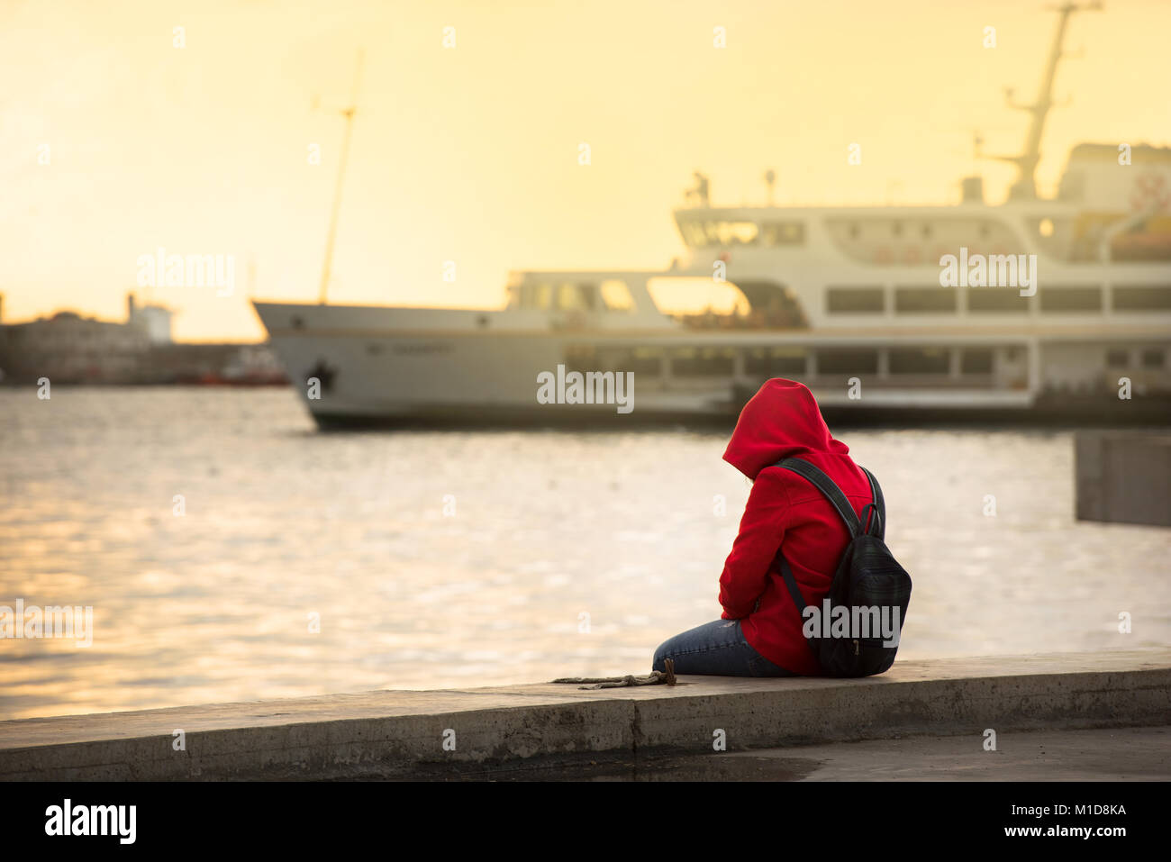 Red-haired girl and passenger ferry Stock Photo