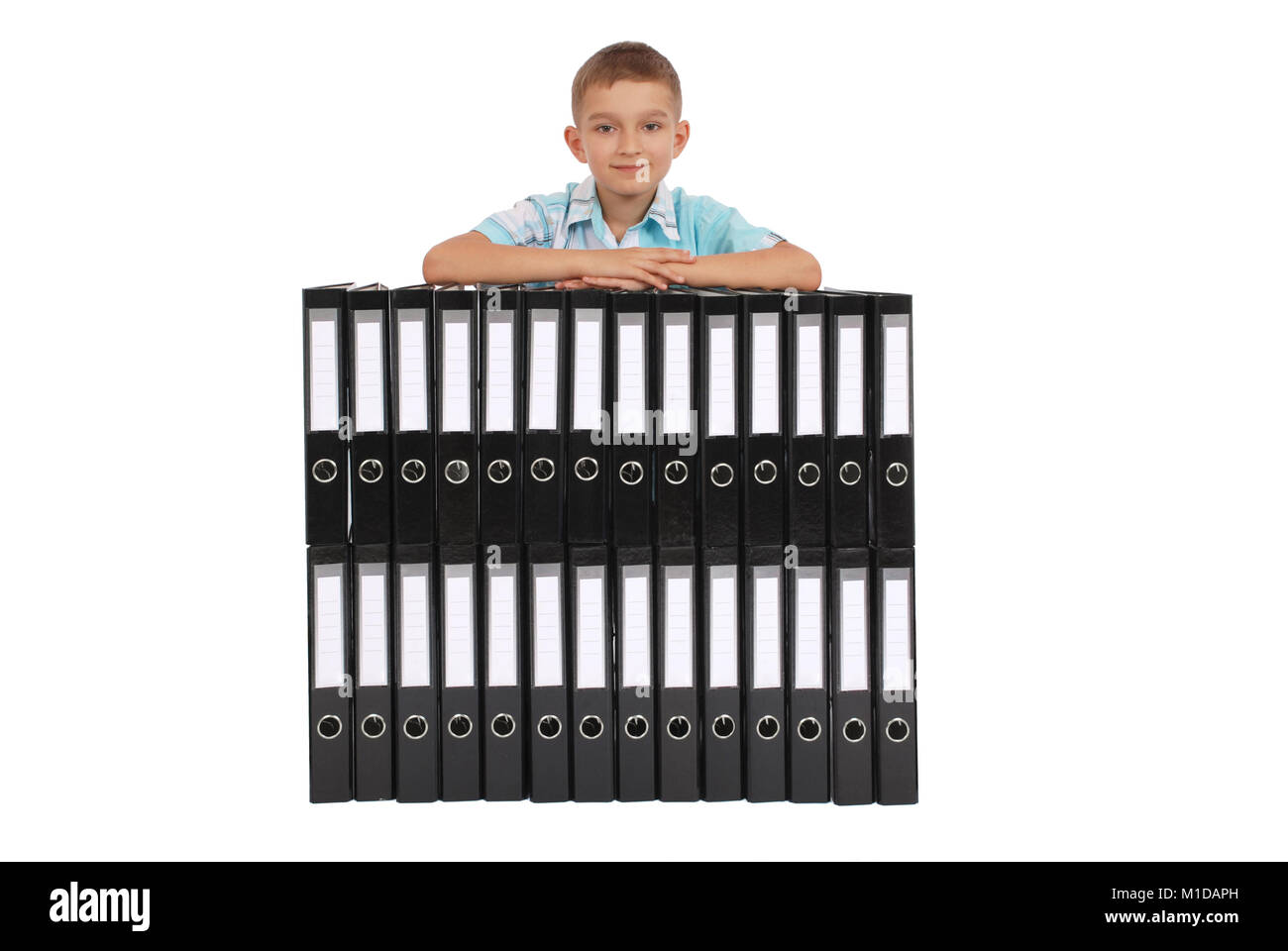 The boy bases on many big black folders on a white background Stock Photo