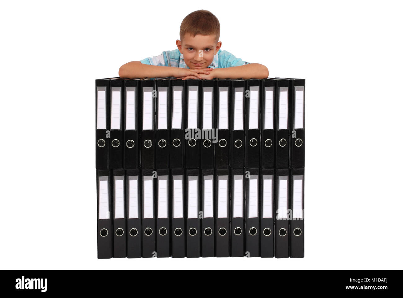 The boy bases on many big black folders on a white background Stock Photo