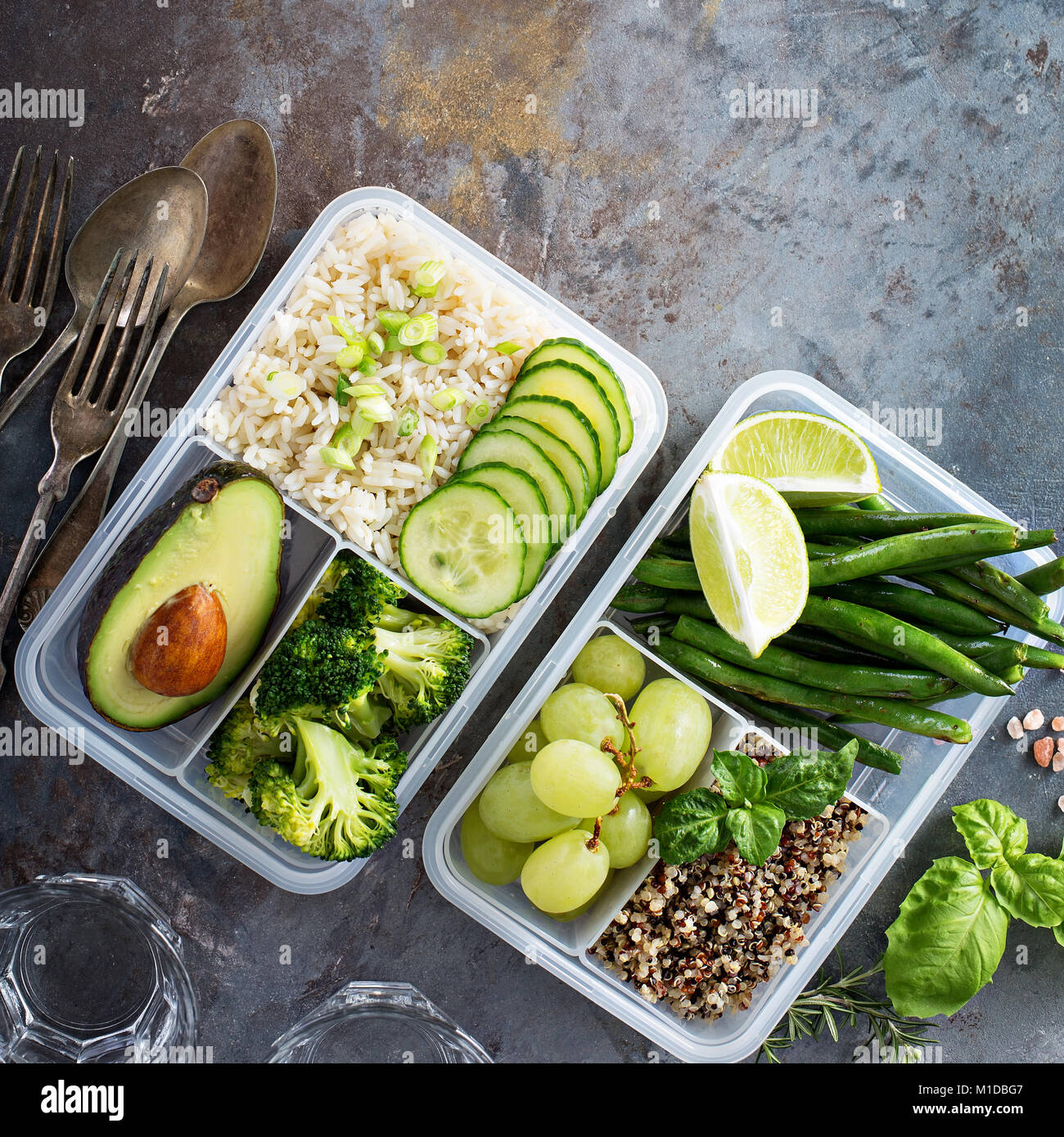 Vegan green meal prep containers with rice and vegetables Stock Photo