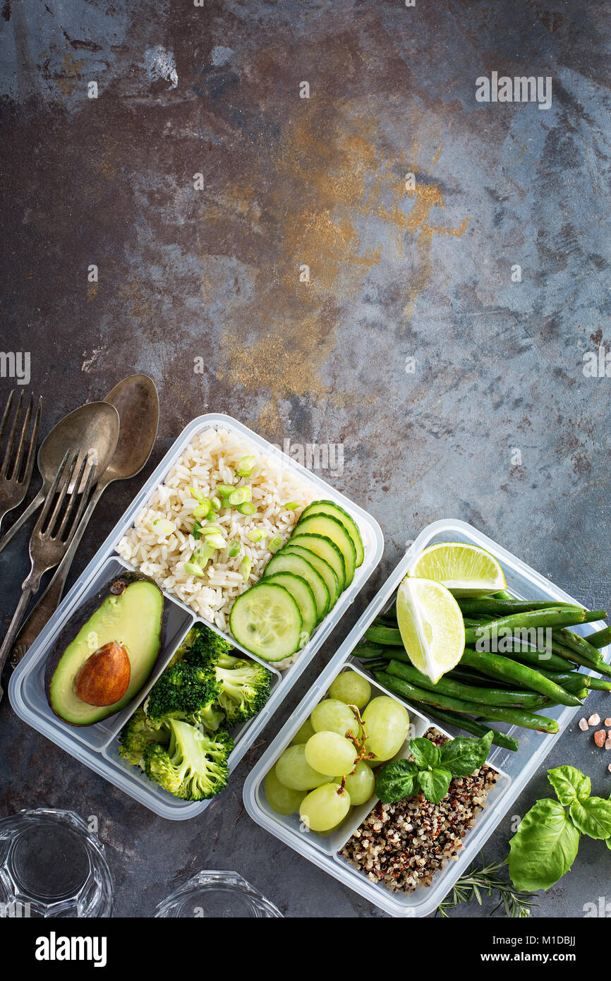 Vegan green meal prep containers with rice and vegetables Stock Photo