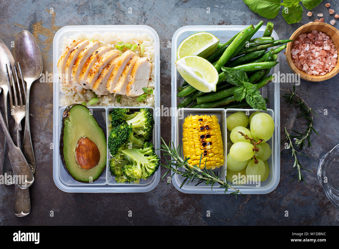 Healthy green meal prep containers with rice and vegetables Stock Photo