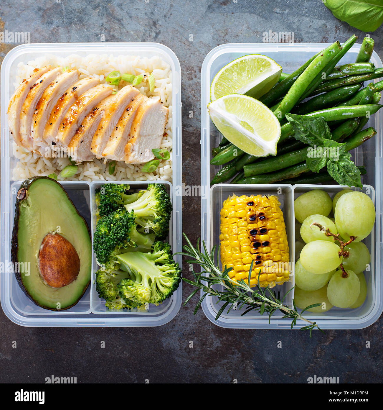 Healthy green meal prep containers with rice and vegetables Stock Photo