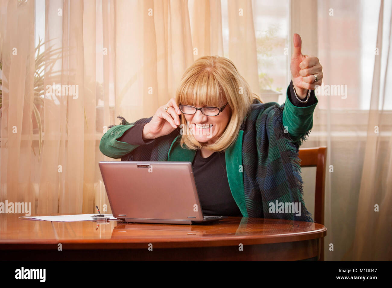 Elderly business woman receiving fantastic news Stock Photo