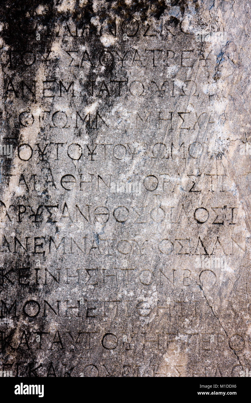 Ancient background, greek text letters carved in stone. Selcuk / Turkey Stock Photo