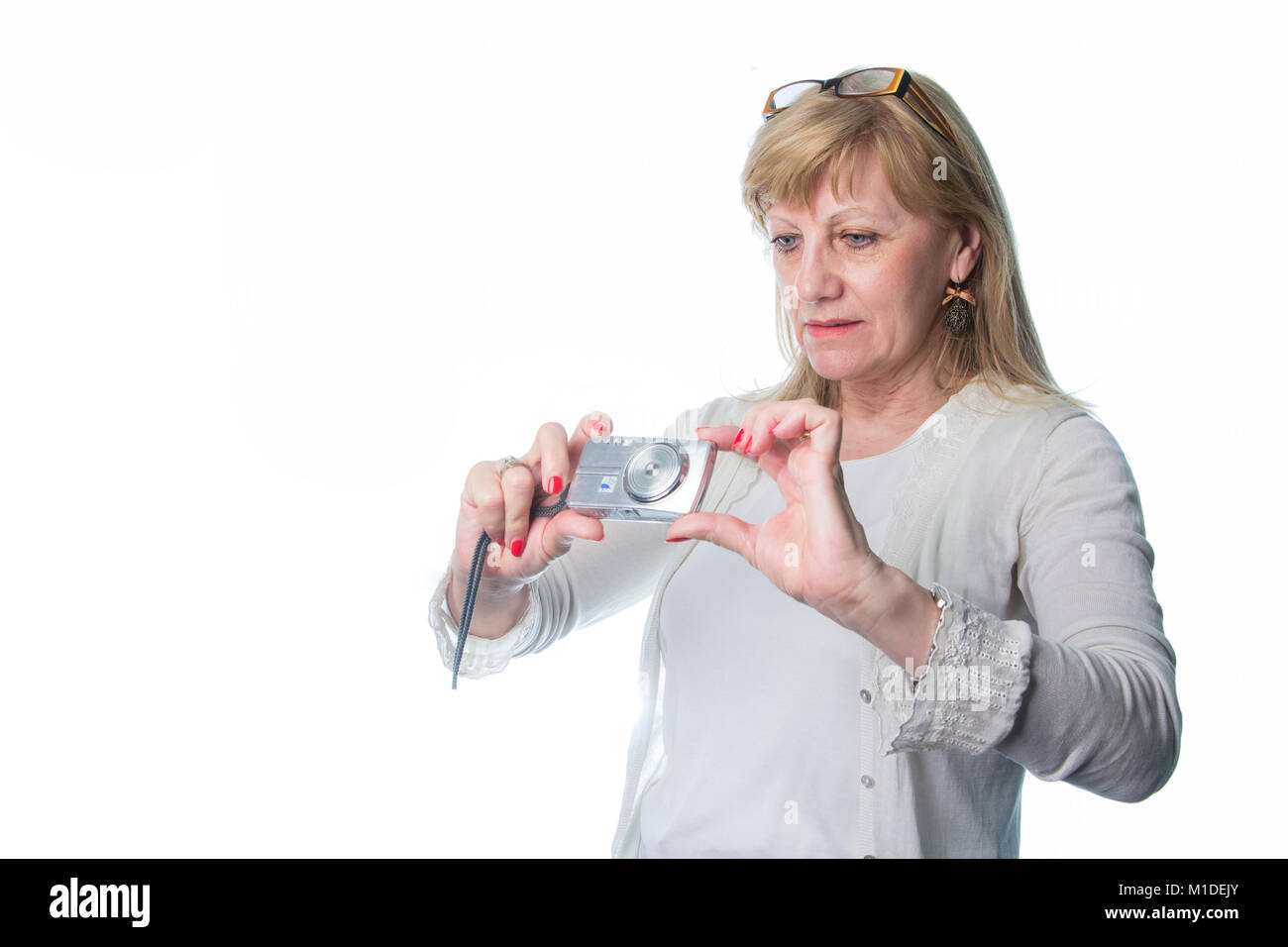 Elderly lady using a compact camera Stock Photo - Alamy