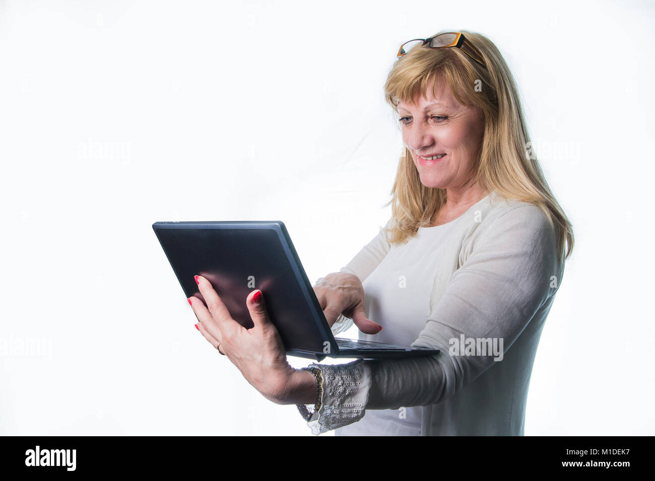 Happy senior lady using her laptop Stock Photo