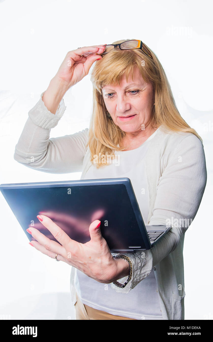 Elderly lady confused with her personal computer Stock Photo