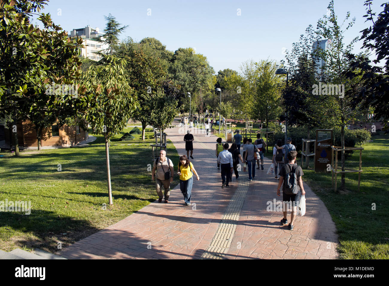 View of people walking at park in Nisantasi / Istanbul in sunny summer day. Stock Photo