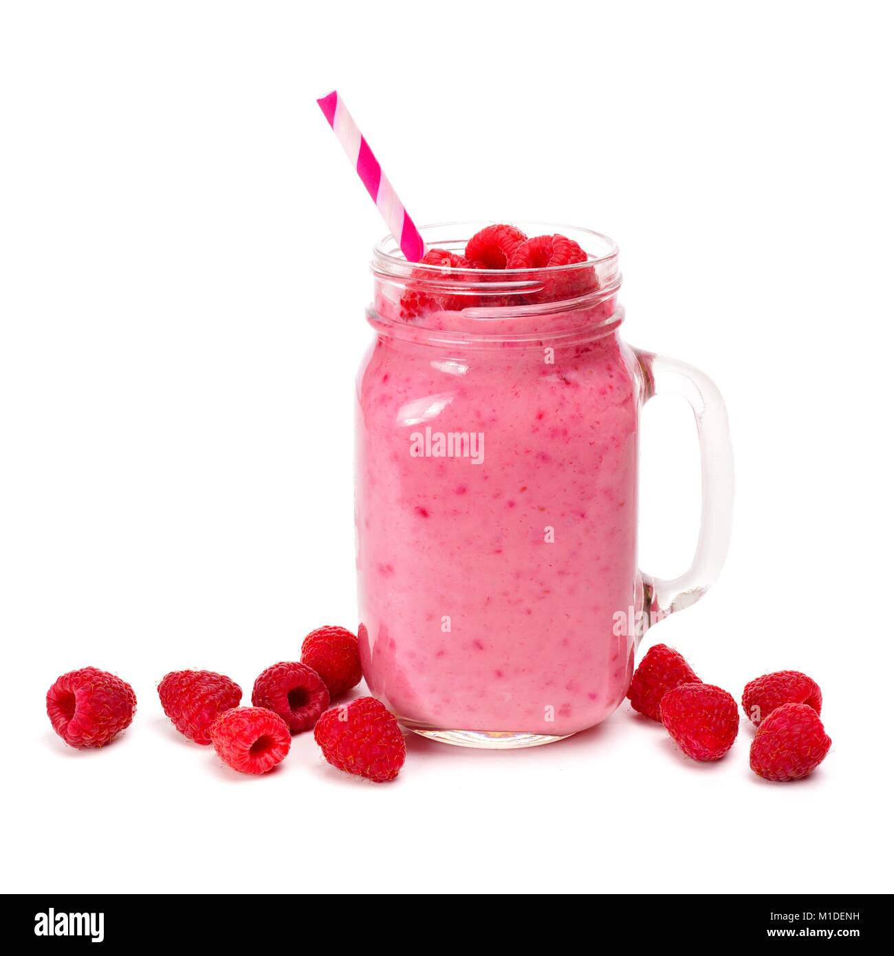 Raspberry smoothie in a mason jar glass with straw and scattered berries isolated on white Stock Photo
