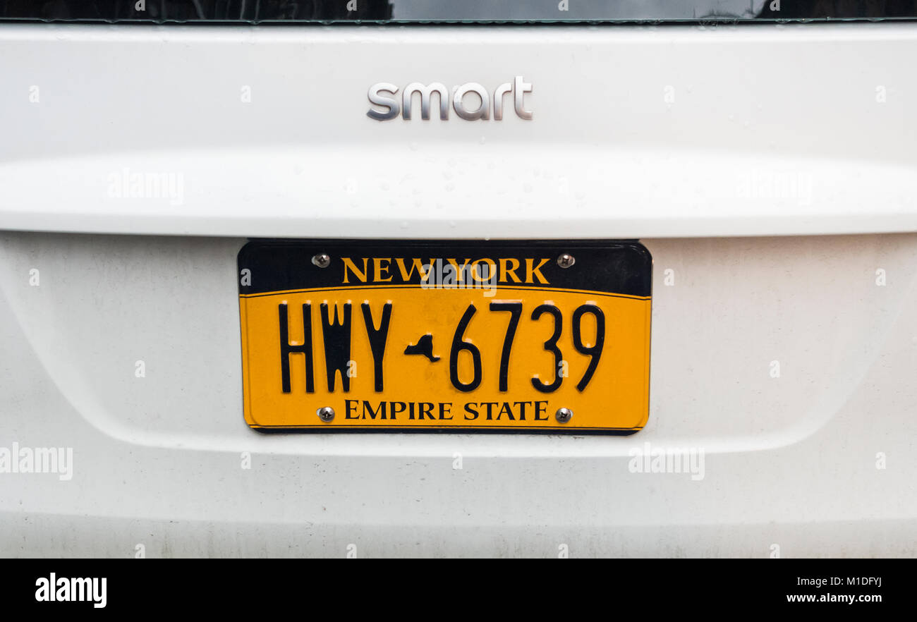 New York license plate on a white Smart Car Stock Photo