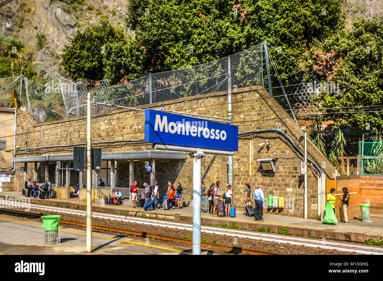 Travelers wait for the next train at the Monterosso al Mare train station in Cinque Terre, Italy on the Ligurian coast Stock Photo