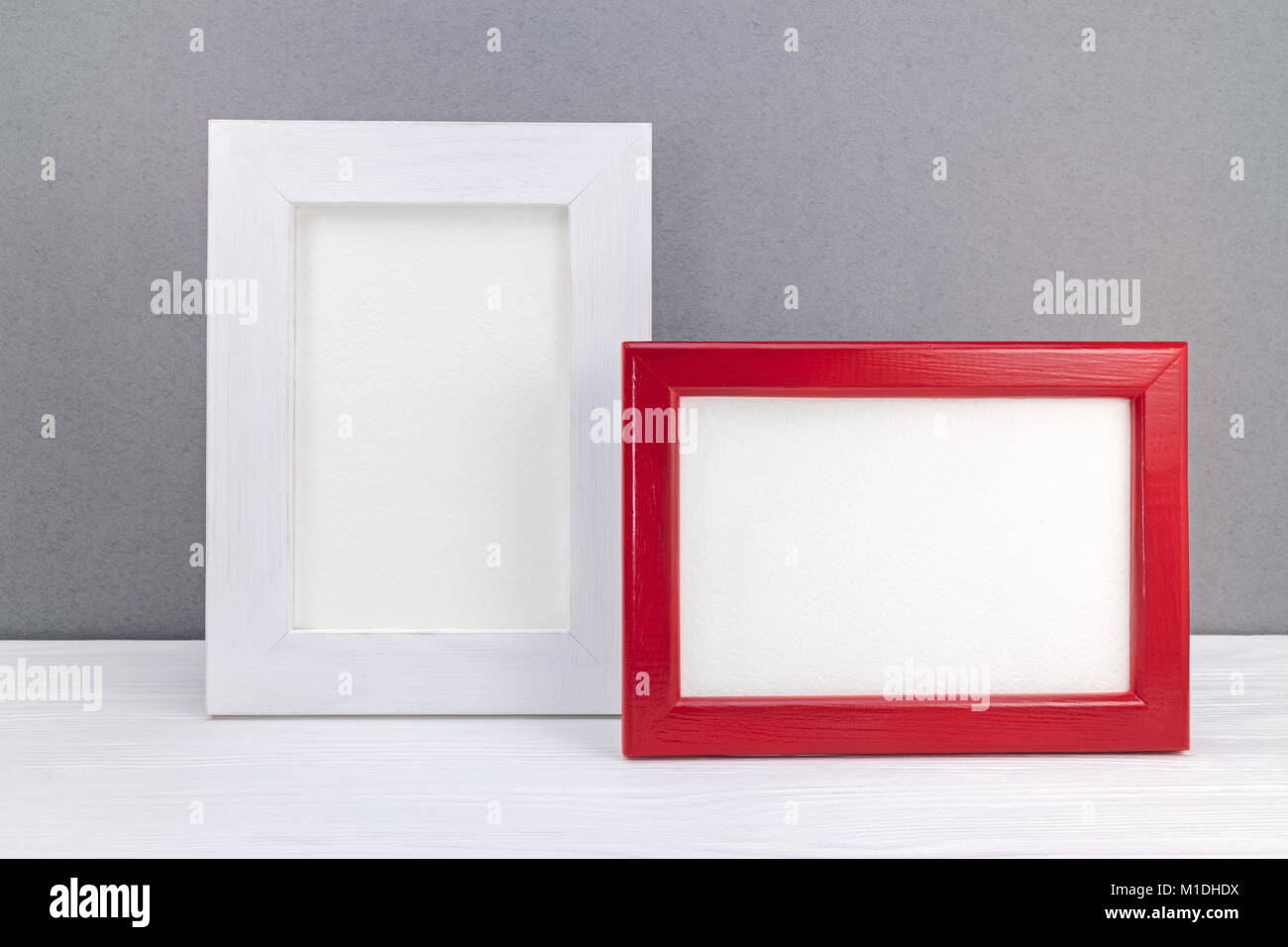 red and white photo frames against grey wall background Stock Photo