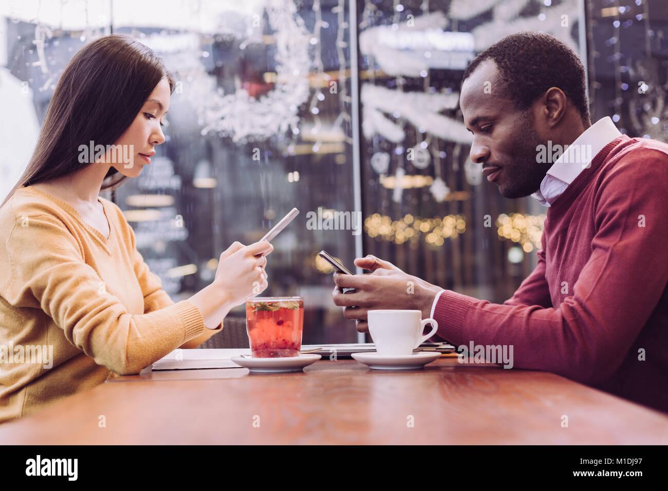 Young concentrated couple distancing from each other Stock Photo - Alamy