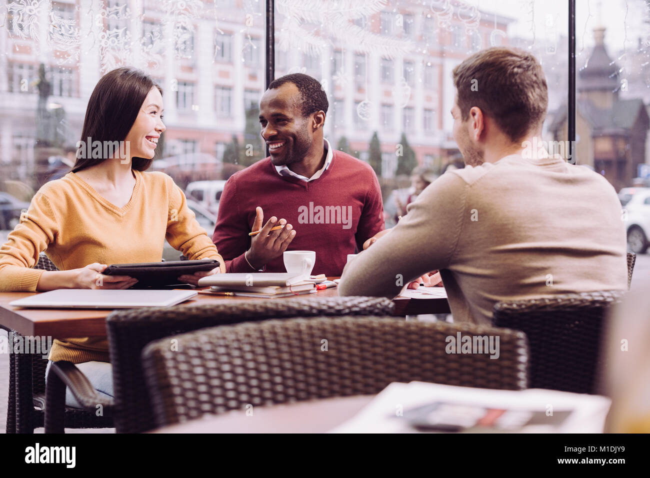 Happy three colleagues creating strategy Stock Photo - Alamy