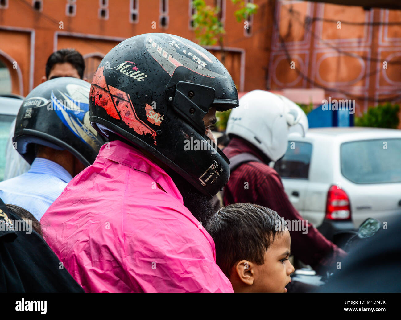 Jaipur, India Jul 27, 2015. People with helmet riding motorbike on