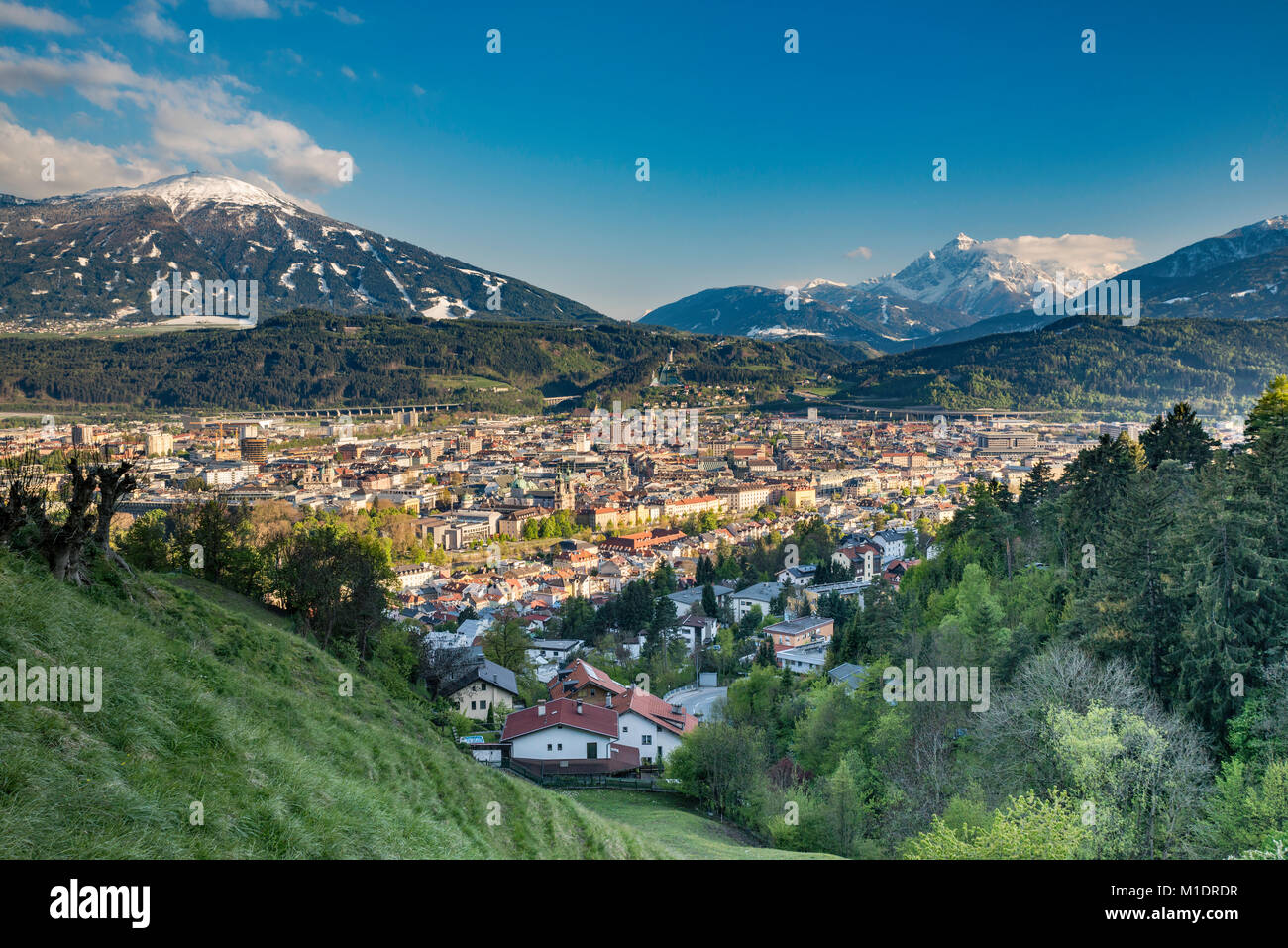 Center of Innsbruck in Lower Inn Valley, Grosse Loffler massif in Zillertal Alps covered with snow in late April in distance, Innsbruck, Austria Stock Photo
