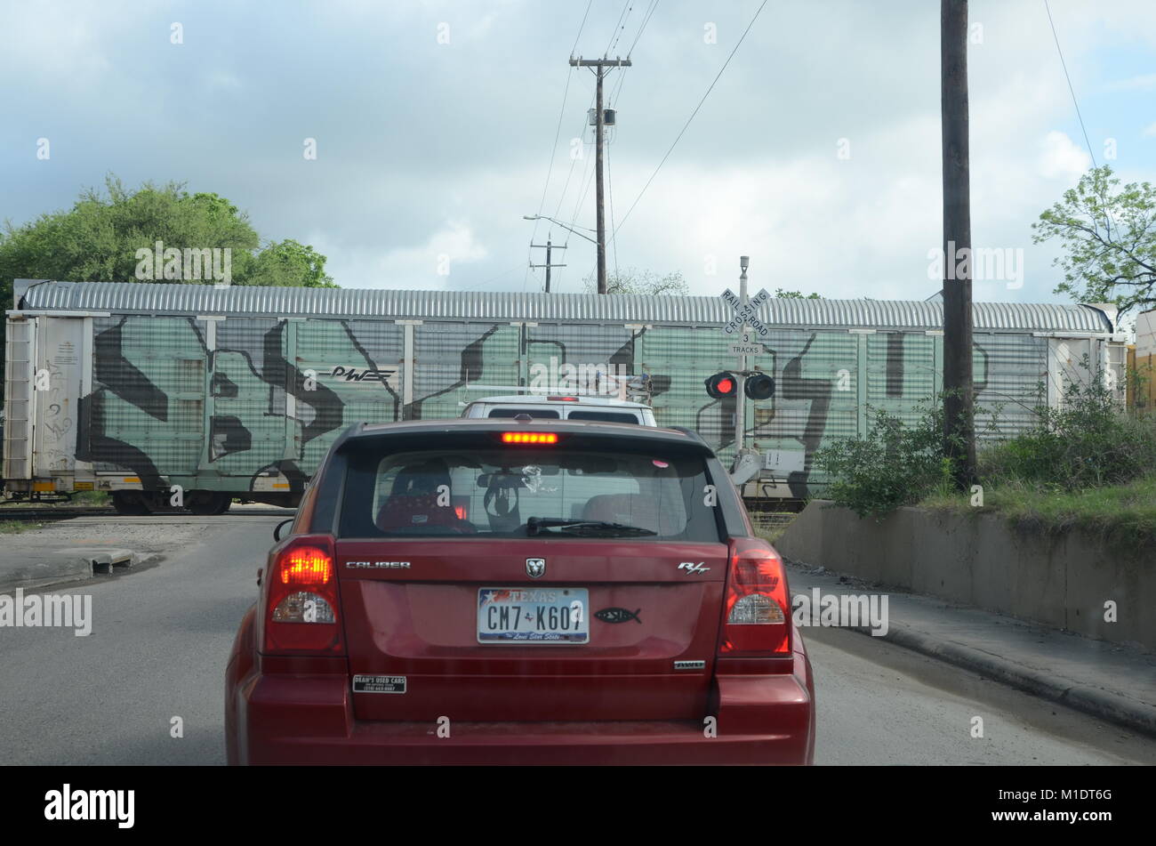 a graffiti covered train crossing a street in san antonio texas Stock Photo