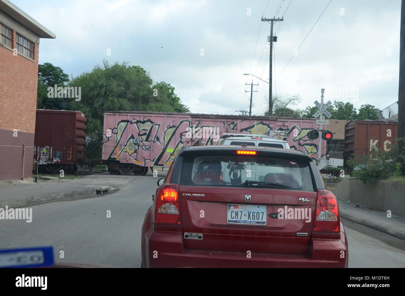 a graffiti covered train crossing a street in san antonio texas Stock Photo