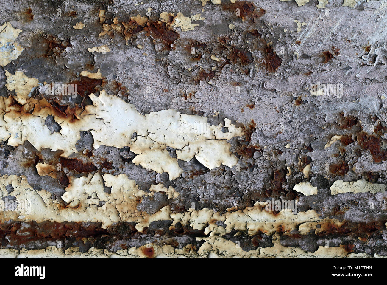 Rusty iron surface with cracks and peeling paint - texture Stock Photo