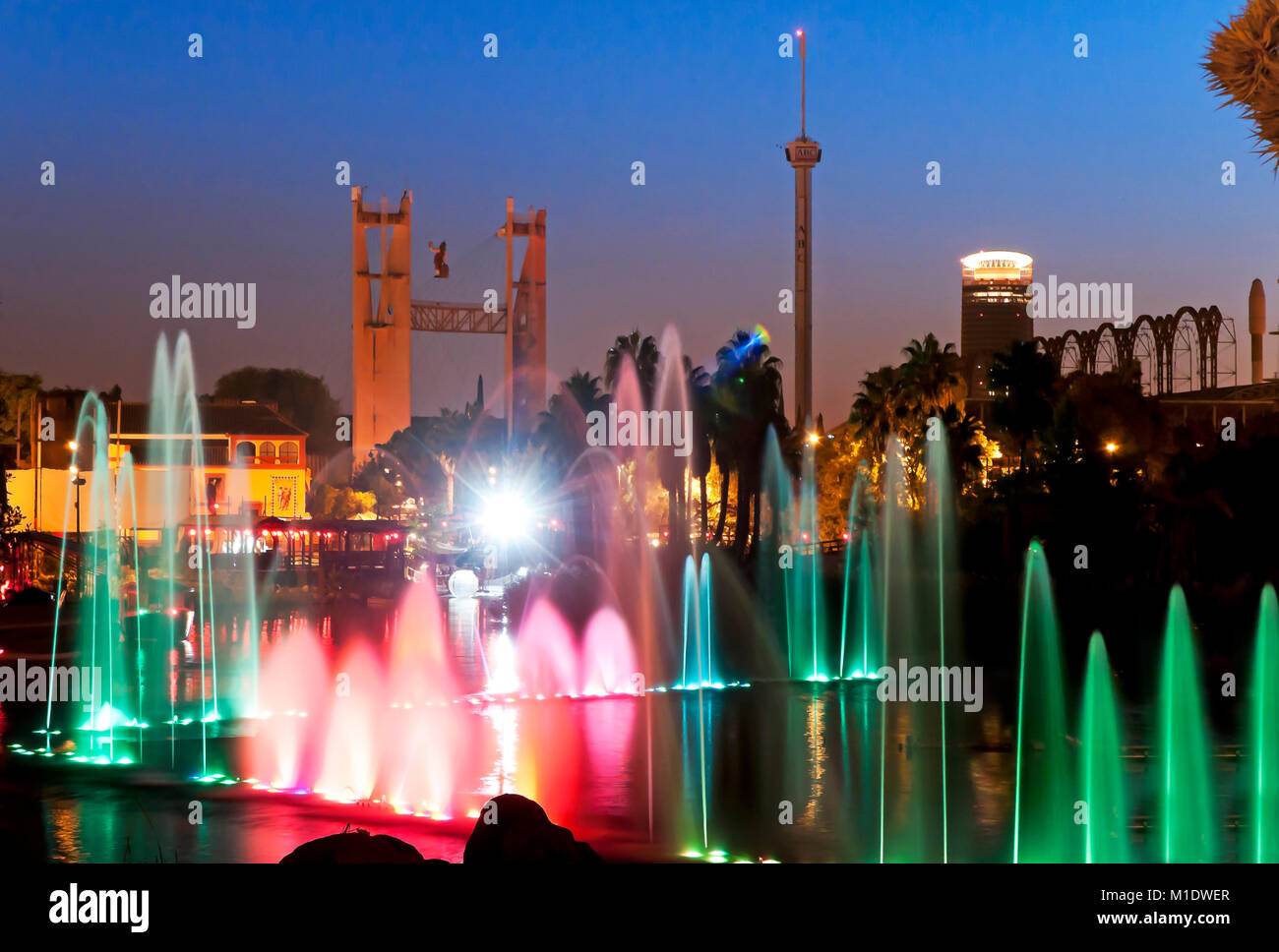 Isla Magica (Magic Island) Theme Park, Lake with water jets at dusk, Seville, Region of Andalusia, Spain, Europe Stock Photo