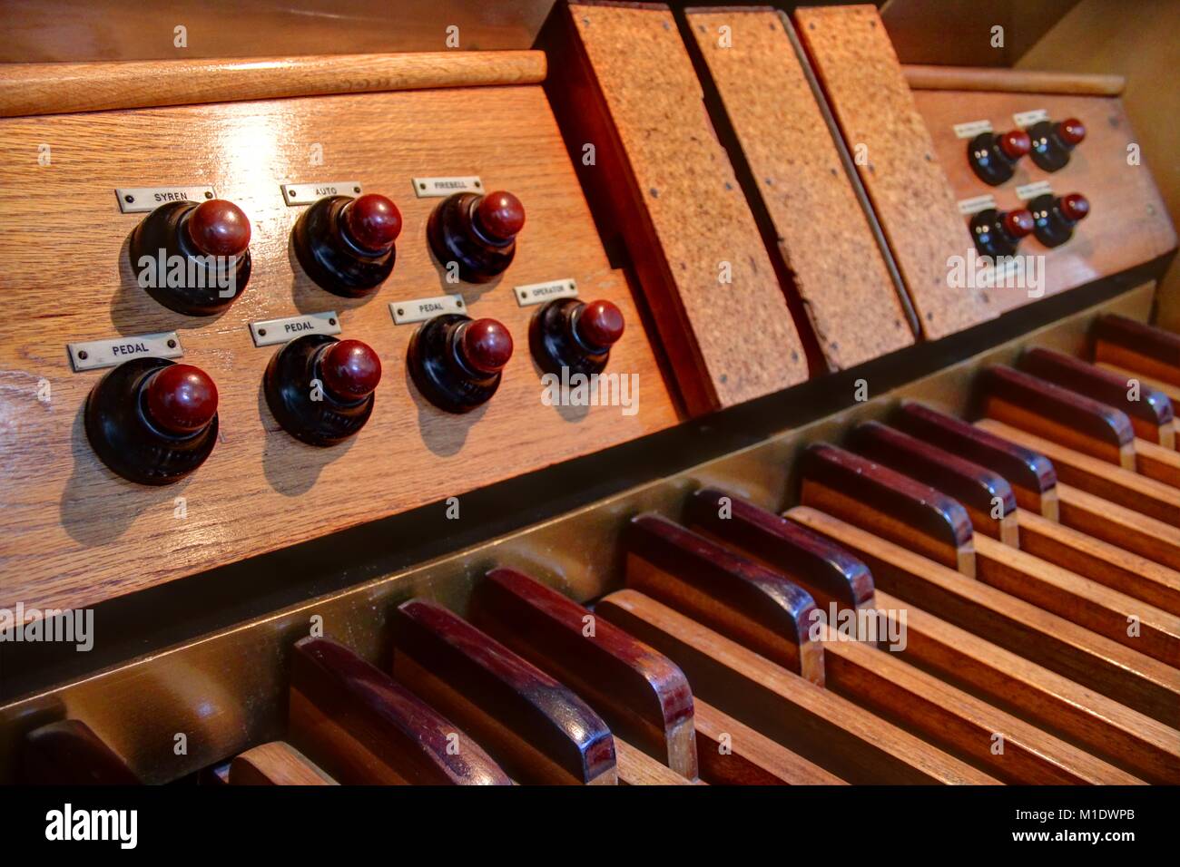 Close up of pipe organ pedalboard, toe pistons and expression pedals. Stock Photo