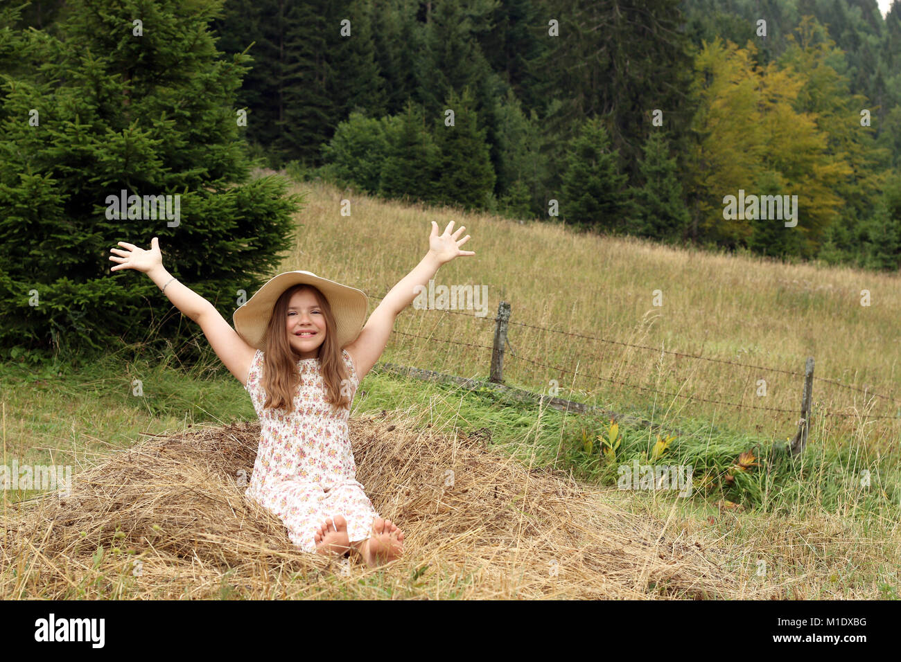 beautiful little girl with hands up enjoys nature Stock Photo - Alamy