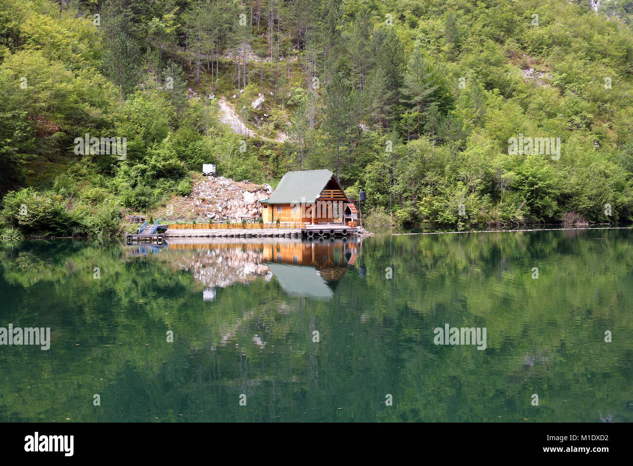 wooden cottage on river landscape Stock Photo