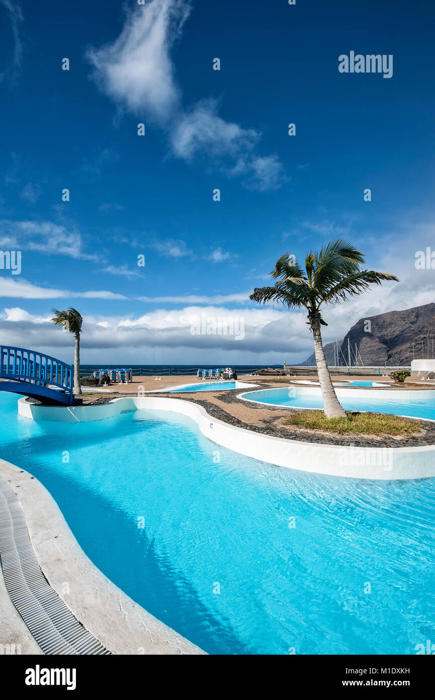 Swimming pool at the port of Los Gigantes with Masca Mountains in the background. Stock Photo