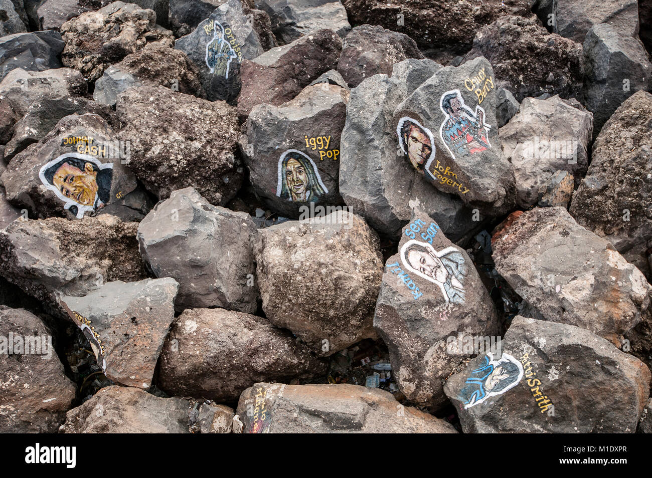 Portraits of famous musicians on rocks on coast in front of the Auditorio de Tenerife Concert Hall designed by Spanish architect Santiago Calatrava. Stock Photo
