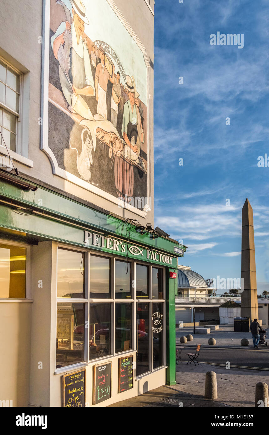 Ramsgate, UK - Jan 22 2018.  The impressive mural above Peter's Fish Factory on the harbour front and a view of the Obelisk, commemorating a visit fro Stock Photo