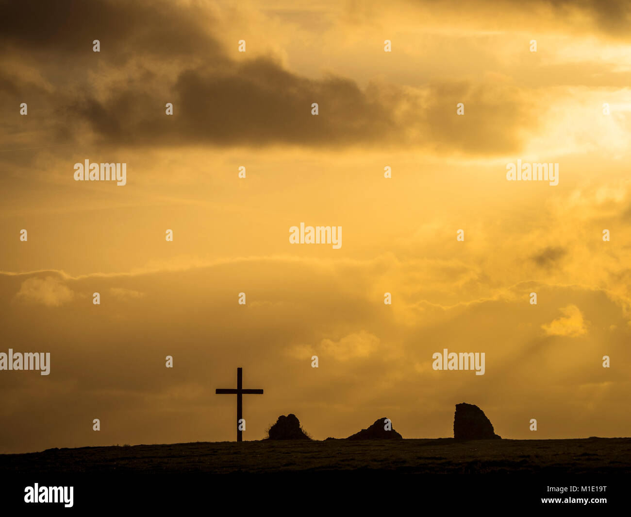 The cross at the remains of St Bennets Abbey at sunrise. Stock Photo