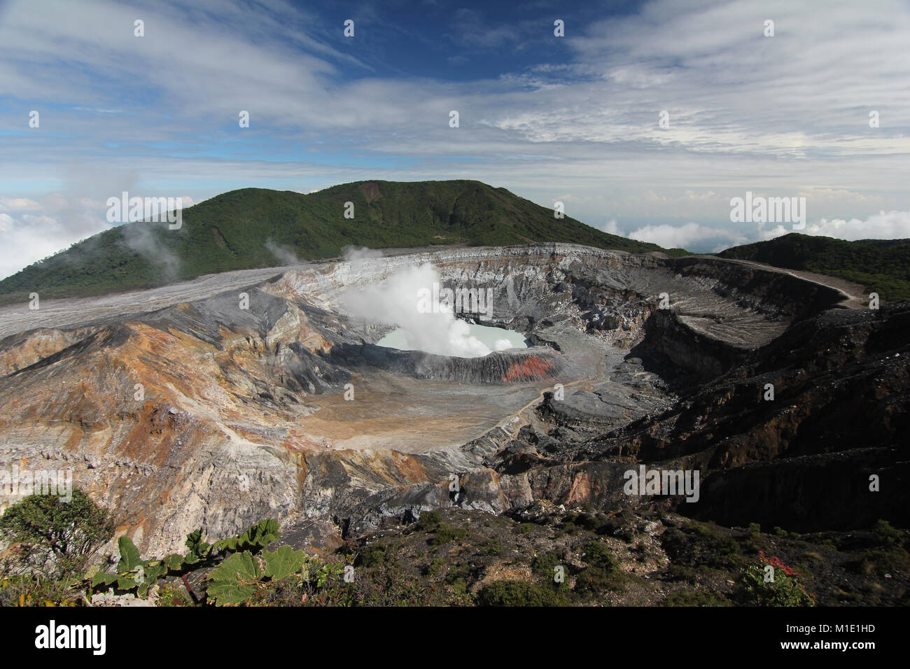 Vulcano Poas in Costa Rica, view into the crater. Stunning view of the steam. Picture taken on a sunny day. Stock Photo