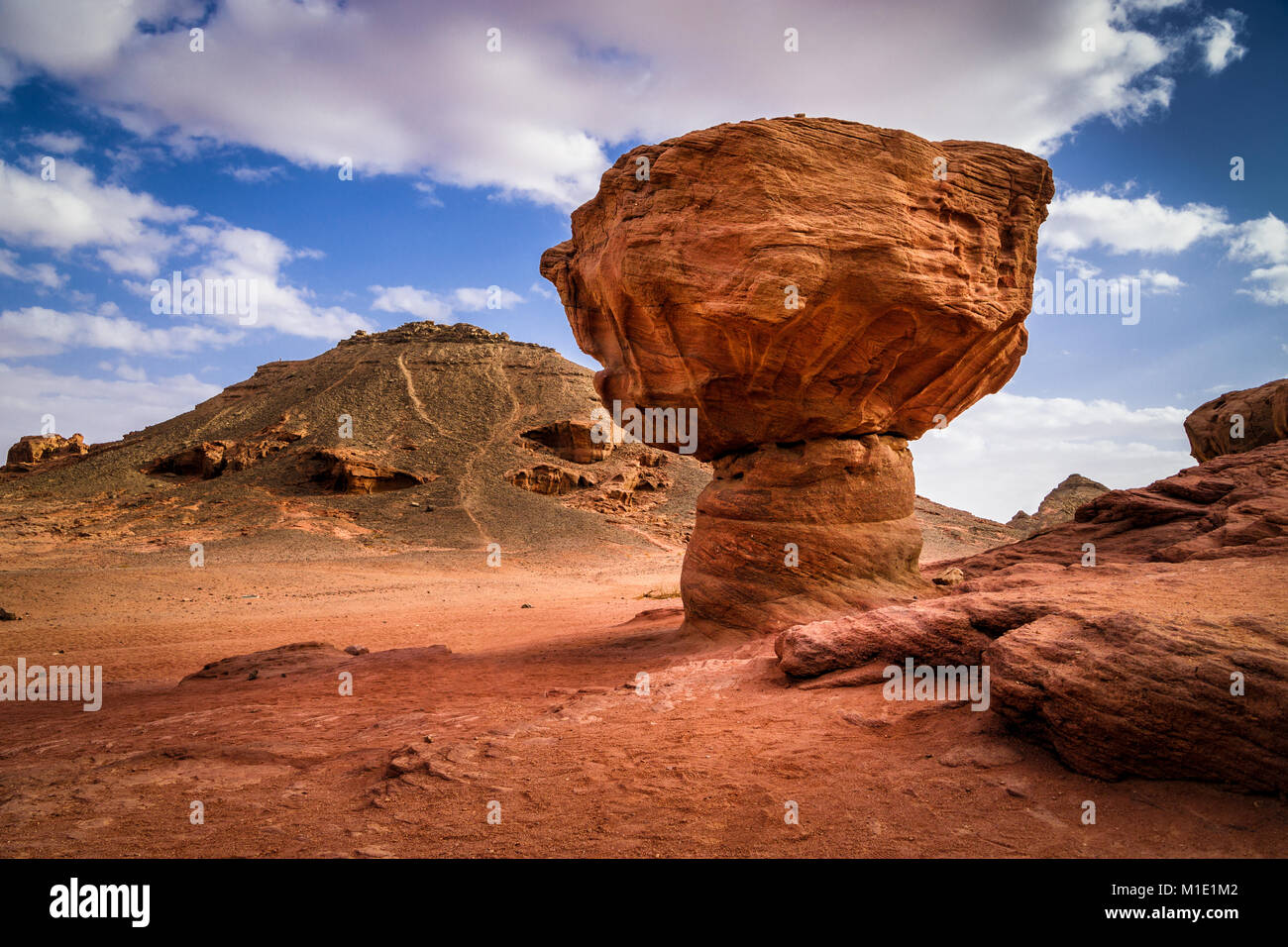 Geological rock formation called mushroom in Timna park in Negev desert, Eilat, Israel. Winter sunny day with fluffy clouds. Stock Photo