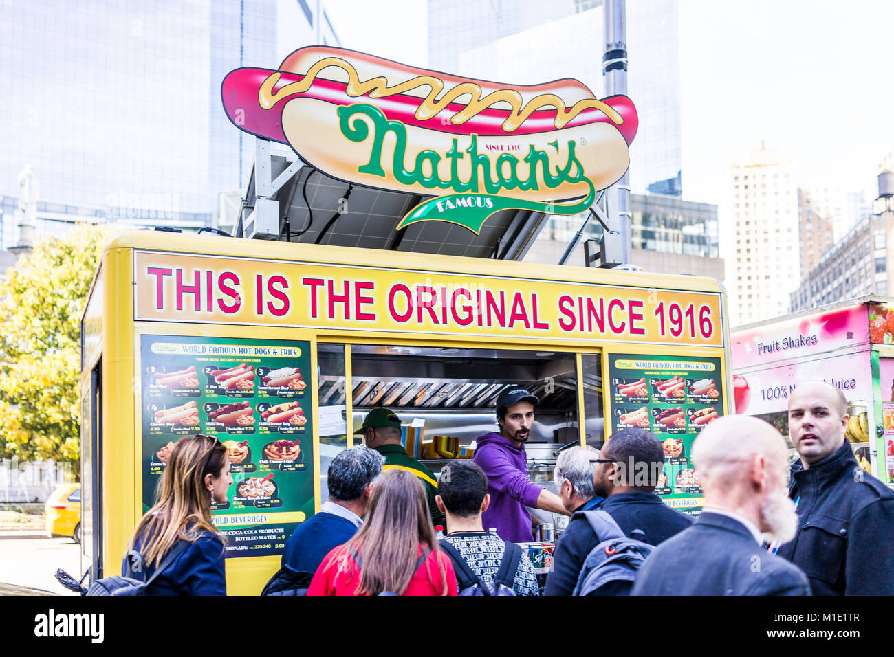 New York City, USA - October 28, 2017: Columbus Circle in Midtown Manhattan NYC, Nathan's Hot Dog Food Truck stand with sign, menu, line queue of peop Stock Photo