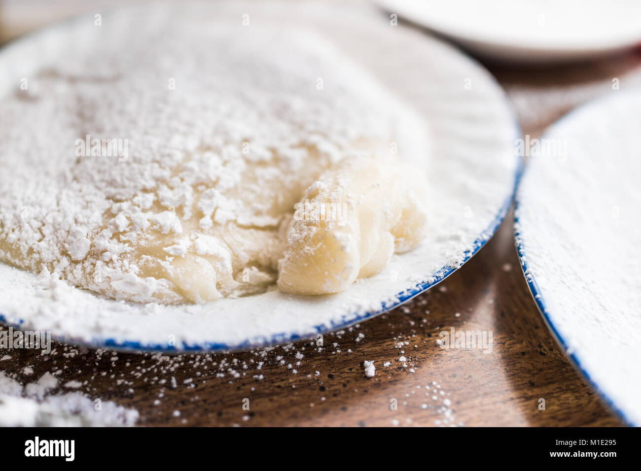 Piece of mochi sticky glutinous rice cake dusted with starch flour to