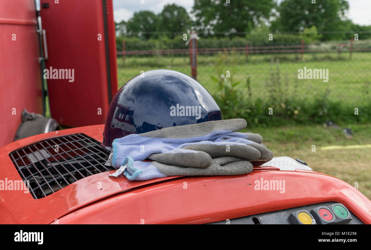 blue protective gloves and safety helmet lie on a fire engine Stock Photo