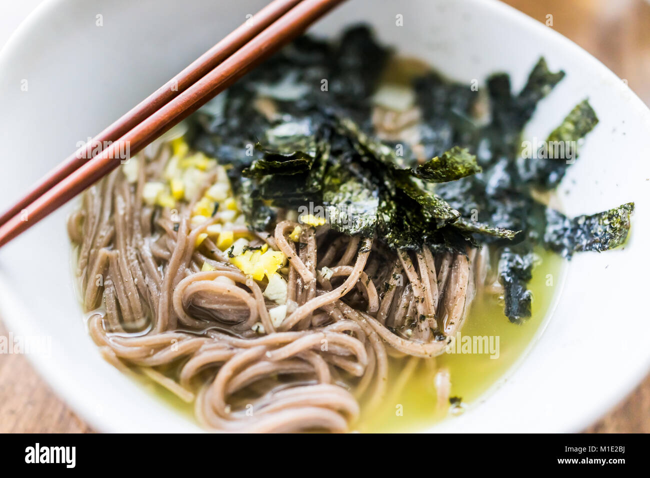 Macro closeup of soba buckwheat noodles Japanese soup with nori seaweed