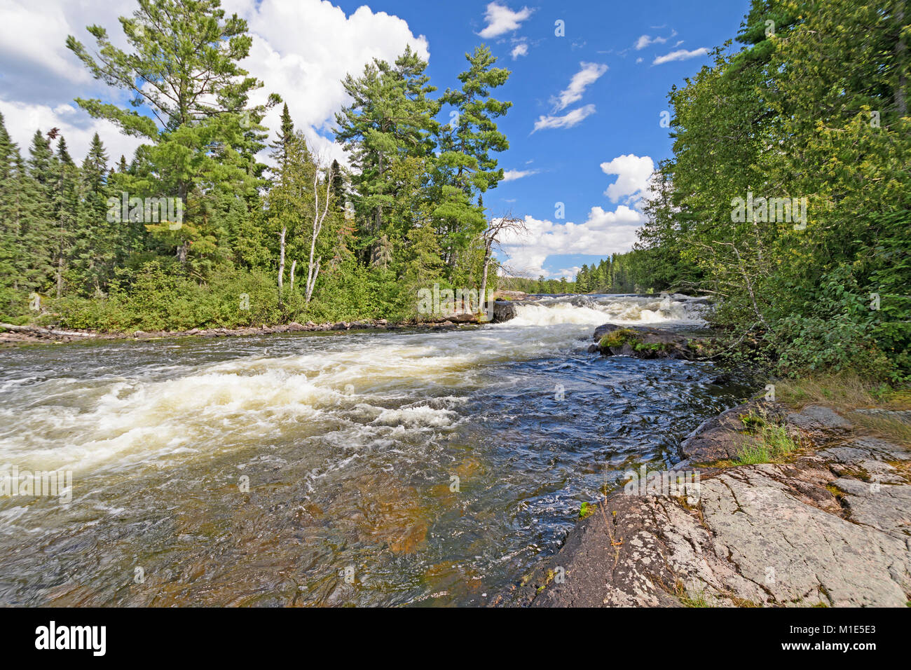 Rushing falls in the North Woods of the Falls Chain in Quetico Provincial Park in Ontario Stock Photo