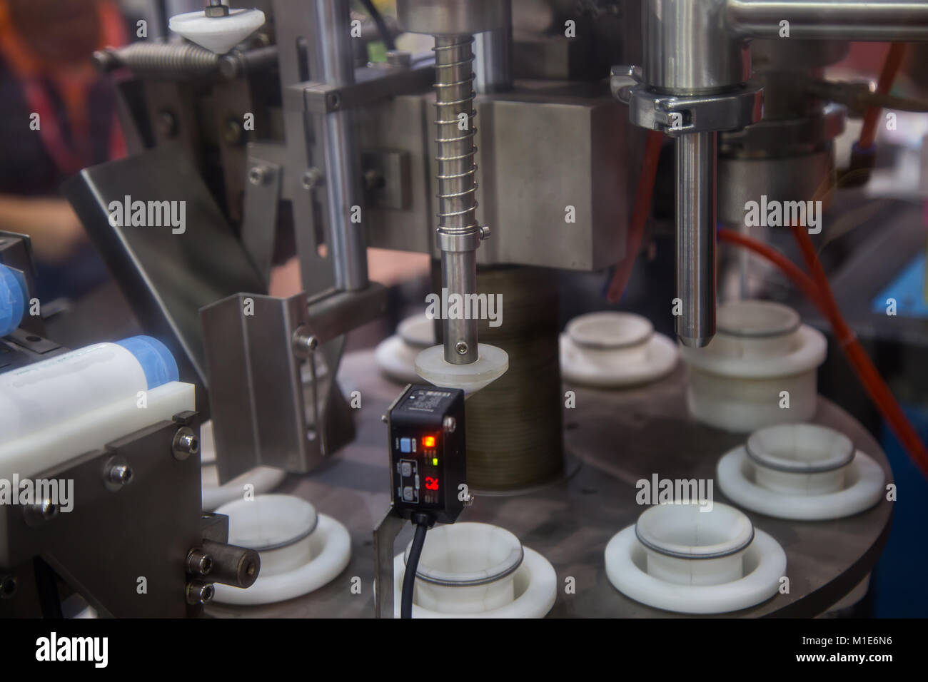 Closeup of automatic bottle capping machine Stock Photo Alamy