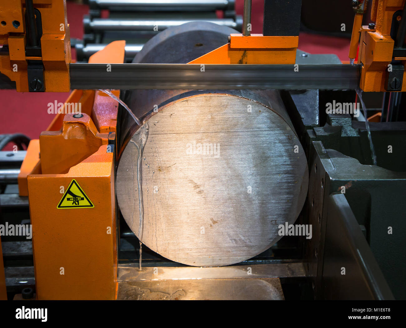 Band saw machine cutting metal work piece with coolant Stock Photo Alamy