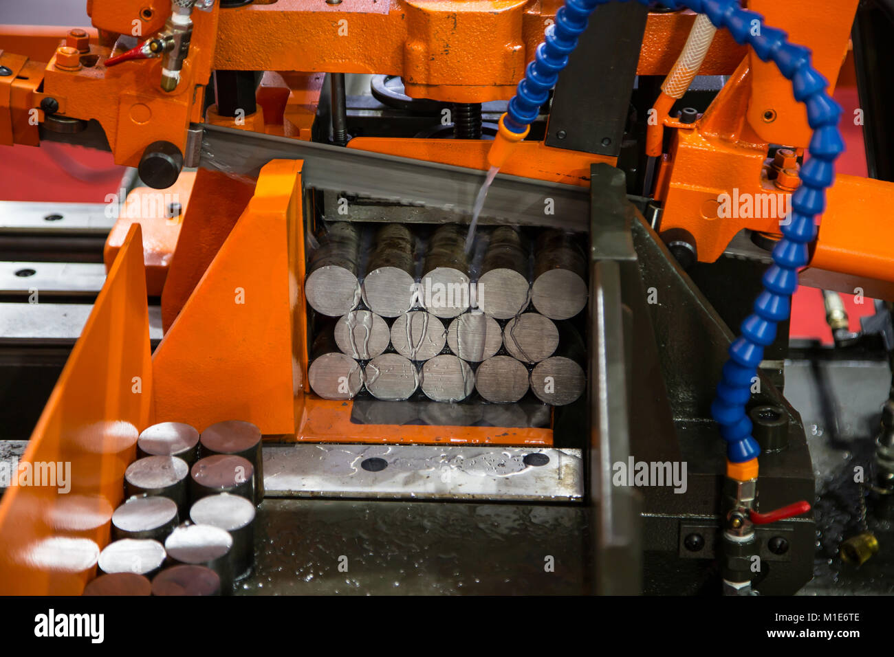 Band saw machine cutting metal work piece with coolant Stock Photo Alamy