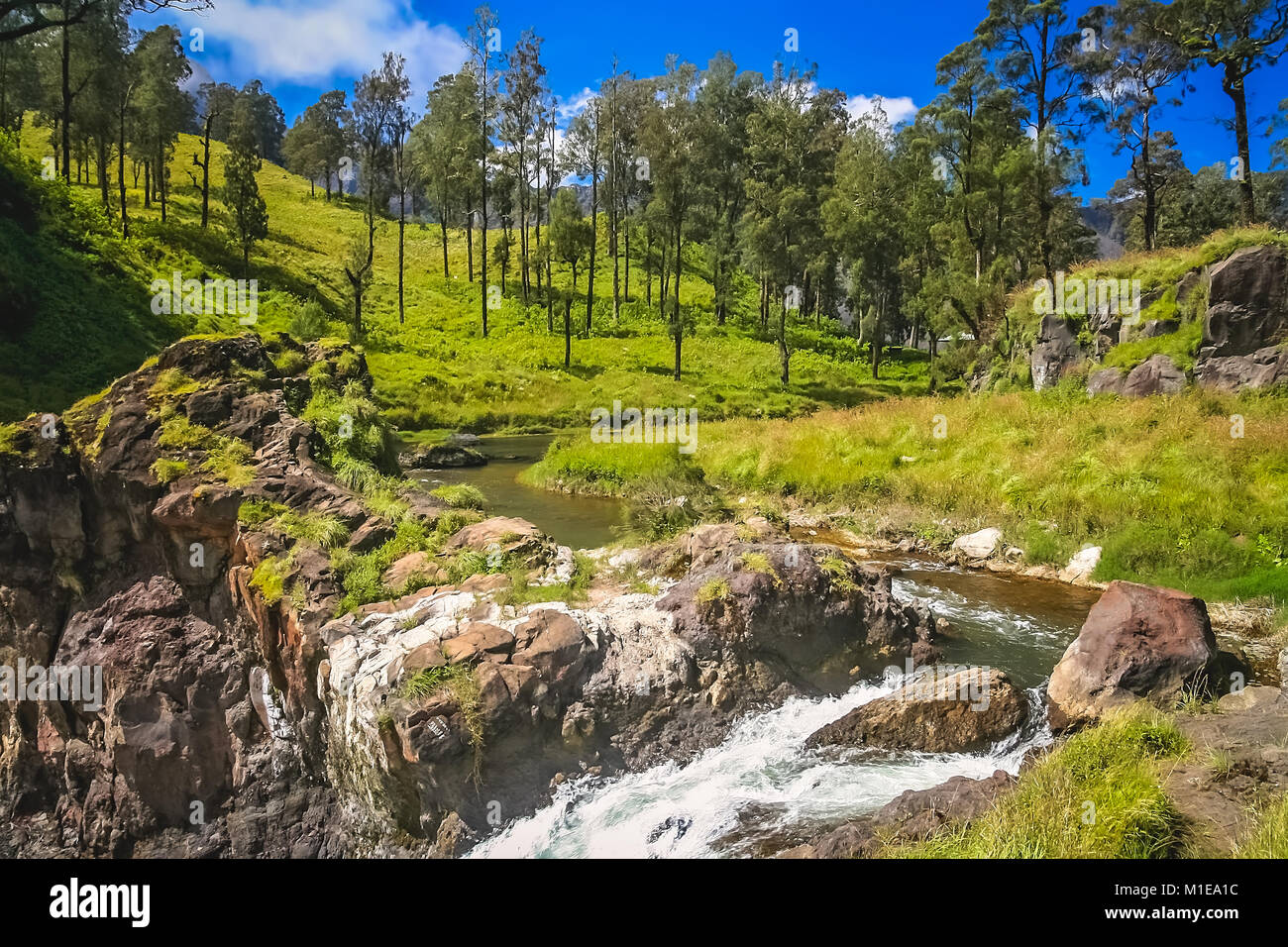River ending in a waterfall with a water coming out of crater lake of