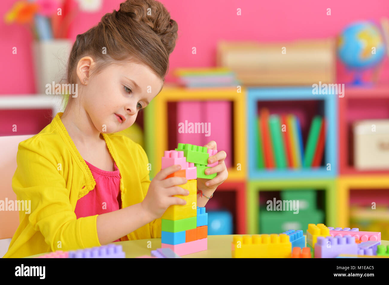 girl playing with plastic blocks Stock Photo - Alamy