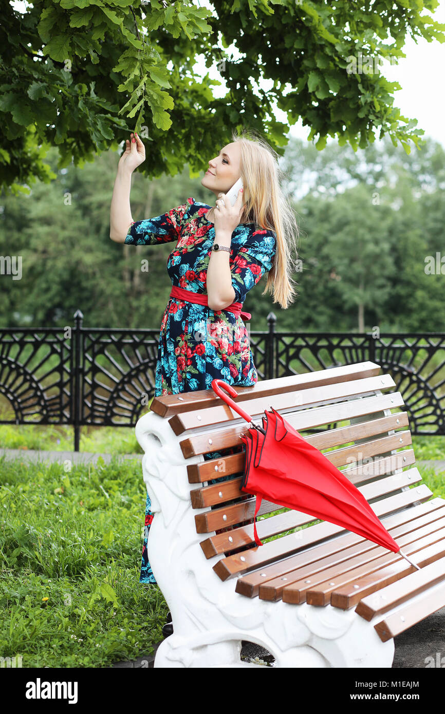 Girl in the street with an umbrella Stock Photo - Alamy