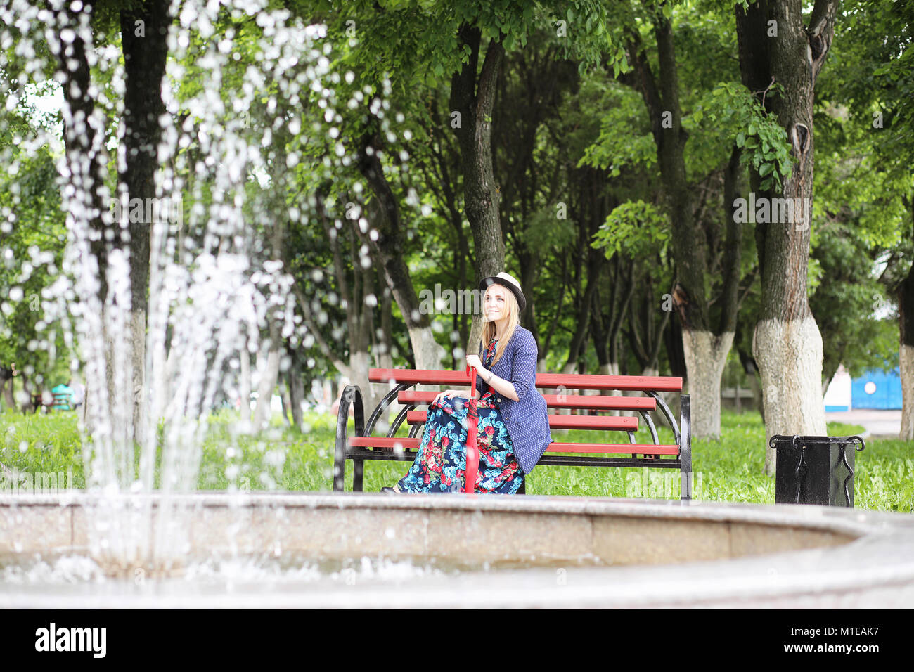 Girl in the street with an umbrella Stock Photo - Alamy